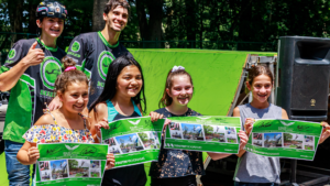 A group of students posing with their free posters following a school assembly in New York State